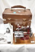 A miniature Essex sewing machine with case.
