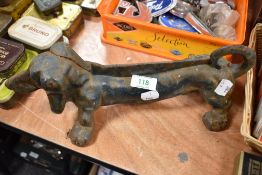 A heavy cast iron boot scraper in the form of a Dachshund.