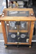 An early to mid 20th century wood and glass cased set of scientific scales.