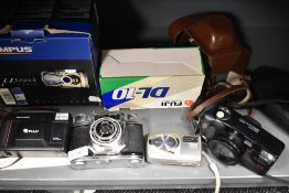 Four cameras. A Fuji DL10 Compact, and Olympus Stylus 410 Digital, a Canon Sureshot 105 and a Halina