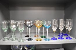A mixed lot of glasses, including coloured glass mid century wine glasses.