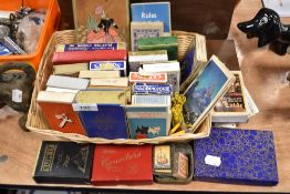 A basket of vintage playing cards, card games and counters.