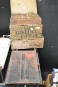 A collection of boxes and crates, including Coopers dipping powder advertising crate and metal