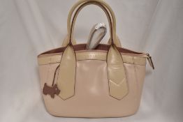 A Radley handbag, having pale pink ground with rose pink accents and signature scottie dog tag.