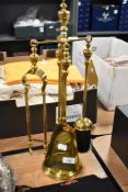 A brass fireside companion set.