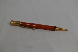 A Parker Duofold Junior propelling pencil in orange. Initials scratched into barrel