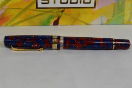An Armando Simoni Club (ASC) Studio Coral piston fill fountain pen in blue red marble with white