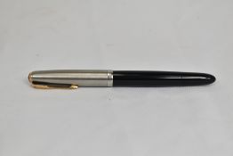 A Parker 51 button fountain pen in black with lustraloy cap having gold clip bearing blue diamond.
