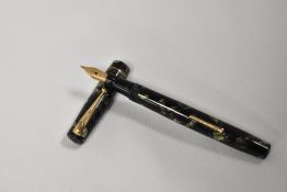 A Mabie Todd & Co Swan leverfill fountain pen in black green marble with two narrow band to the