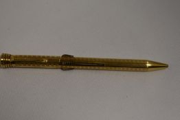 A Super Norma rolled gold four colour propelling pencil. Boxed in good condition some slight flaking