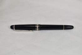 A Montblanc Meisterstuck 144 converter fountain pen in black with platinum plated trim having a