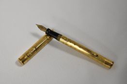 A Mabie Todd & Co Swan leverfill fountain pen gold overlaid engine turned wavy Art Deco pattern