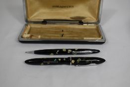 A Sheaffer Balance Junior lever fill fountain pen and propelling pencil set in black/ablone with