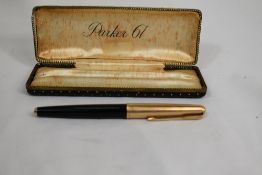A boxed Parker 61 fountain pen in black with a rolled gold cap. Approx 13.5cm good condition