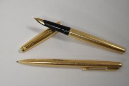 A Parker 65 converter fill fountain pen and propelling pencil set in rolled gold having 14ct