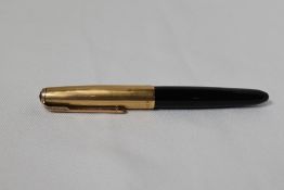 A Parker 51 demi button fill fountain pen in black with gold filled cap. In good condition small
