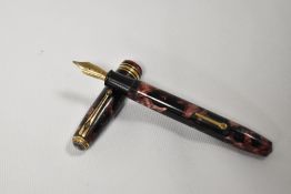 A Conway Stewart 58 leverfill fountain pen in rose and black marble with single broad band and two