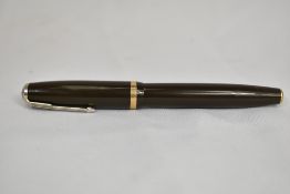 A Parker Duofold button fill fountain pen in Olive green with single decorative band to the cap,