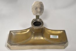 An Art Nouveau metal ink well