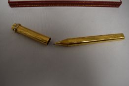 A Cartier Must de Cartier Trinity Vendome Oval Trinity ballpoint pen in a gold metal with tri-colour