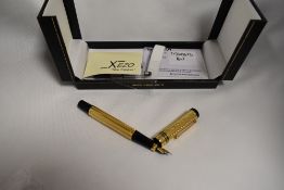 A boxed Xezo Tribute limited edition cartridge converter fountain pen. 18k gold plating with black