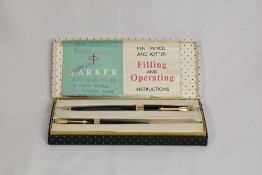 A boxed Parker Super 17 aeromatics fill fountain pen and propelling pencil in black with broad