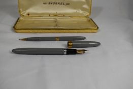 A boxed Sheaffer Snorkel fountain pen and propelling pencil set in grey having Sheaffer 14k nib.