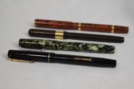 Four Mabie Todd fountain pens. A Swan Safety cao No2 eyedropper in BHR, a Swan SF230C lever fill
