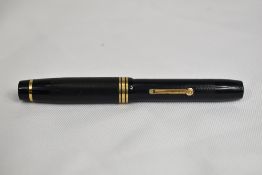 A De la Rue Onoto Magna lever fill fountain pen in black with one broad and two narrow bands to