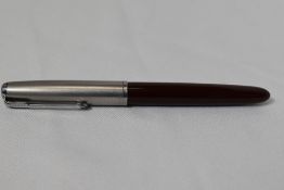A Parker 51 button fill fountain pen in burgundy with lustraloy cap. In good condition