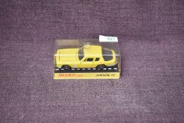 A Dinky diecast, 188 Jensen FF in yellow with black interior, on card stand under plastic case