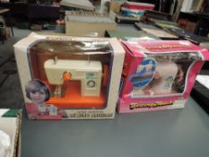 Two Child's Hand Operated Sewing Machines, made in Hong Kong and China, both in display boxes