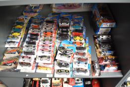 A shelf of Mattel Hot Wheels diecasts, all on display hanging bubble cards or boxed sets, 100+