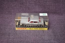 A Dinky diecast, 164 Mk4 Ford Zodiac in silver with red interior, on card stand under plastic case