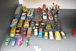 A collection of payworn diecasts including Corgi, Dinky, Lesney etc along with four wooden figures