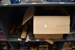A shelf of 0 gauge including two Hornby style Loco's af, three carriages, track and accessories