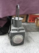 A Railway Lamp having front and rear bulls eye lens and carry handle, no marking seen, height