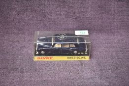 A Dinky diecast, 152 Rolls Royce Phantom V Limousine in dark blue with cream interior, on card stand