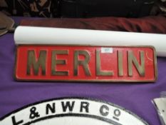 A Brass Merlin Loco Plate, painted red with gold lettering and border, 43cm x 11cm, complete with f