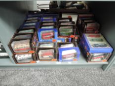 A shelf of EFE diecasts including De Luxe Buses and Wagons, Fishermans Friends and similar sets, all