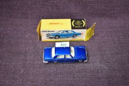 A Dinky diecast, 160 Mercedes-Benz 250 SE in metallic blue with white interior, on original card