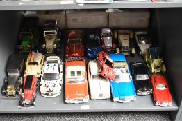 A shelf of playworn diecasts including 1:18 scale Maisto 1971 Chevrolet Chevelle and Jaguar MKII,