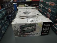 Seven 1997 Corgi Classics The Beatles Collection diecasts along with card and paper records with