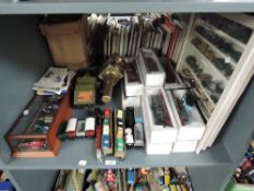 A shelf of diecasts, 00 gauge models, Meccano and a brass Carriage Lamp
