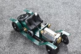 A Mamod Live Steam Roadster in dark green with black seats and silver bonnet