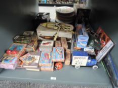A shelf of modern reproduction Toys and Games including Home Run Chewing Gum Van, Hornby Porsche