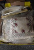 A selection of vintage linen including table mats, embroidery and lace work.