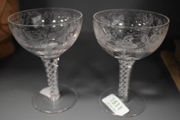 A pair of etched glass twist stem glasses.