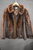 A vintage mid length ladies dark fur coat.