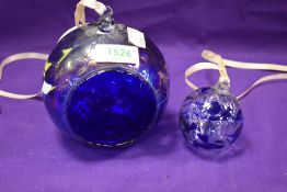 A modern art glass hanging basket with a similar hand blown ball.